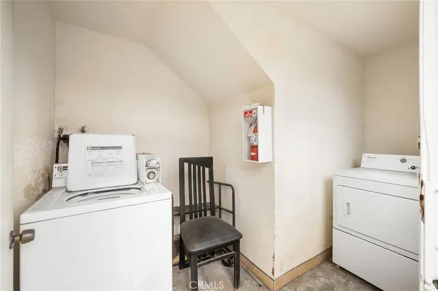 a view of storage and utility room with washer and dryer