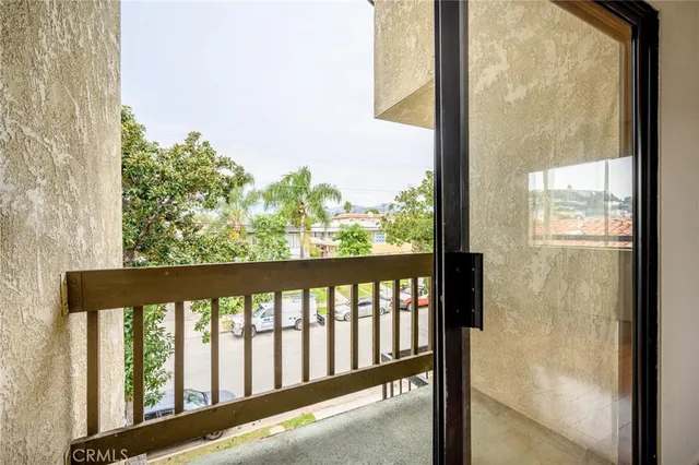 a view of a balcony with wooden floor