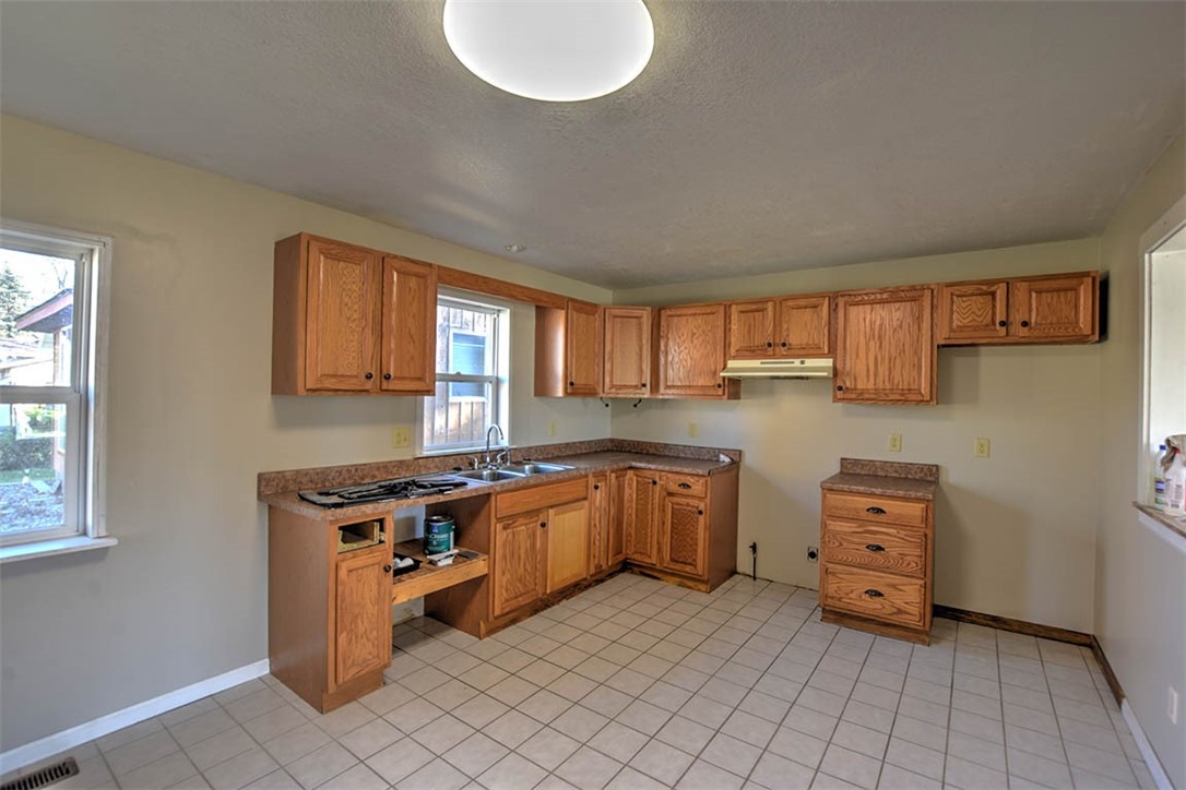 1502 North Fairview Avenue Decatur, IL 62526 - Photo 9 of 14 a kitchen with stainless steel appliances granite countertop a stove a sink and a refrigerator