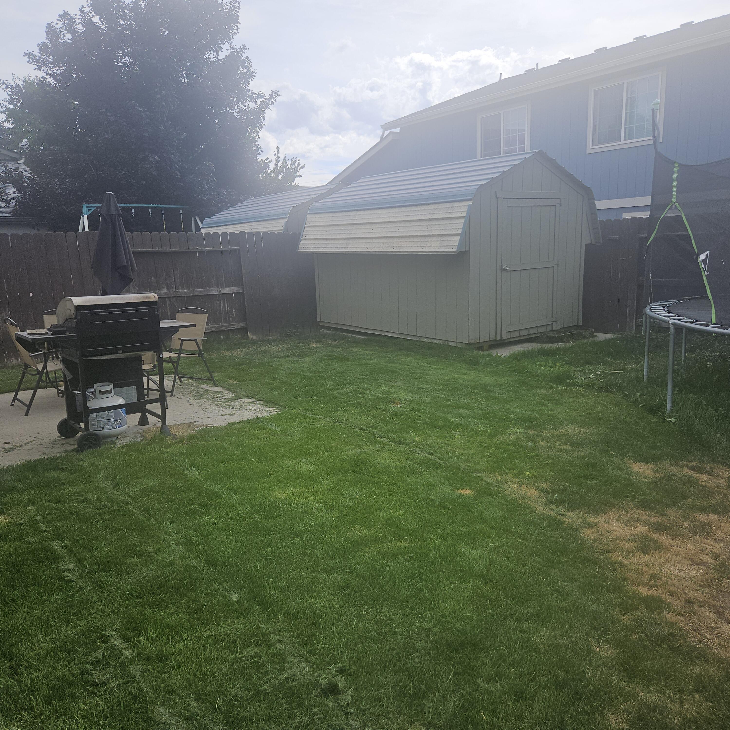 569 Northeast Negus Loop Redmond, OR 97756 - Photo 24 of 32 a backyard of a house with table and chairs