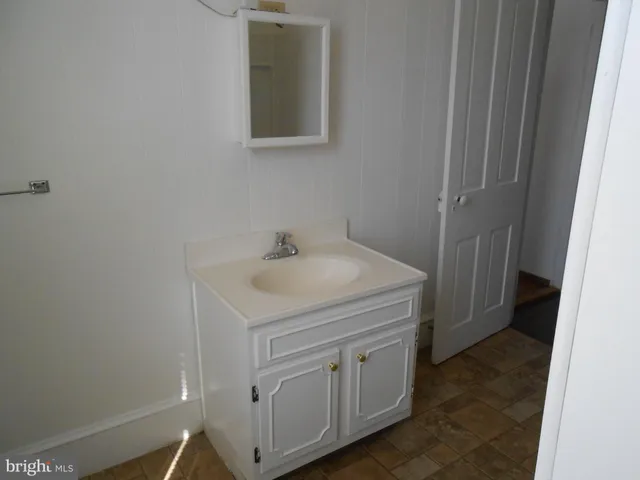 a dining room with furniture and a refrigerator