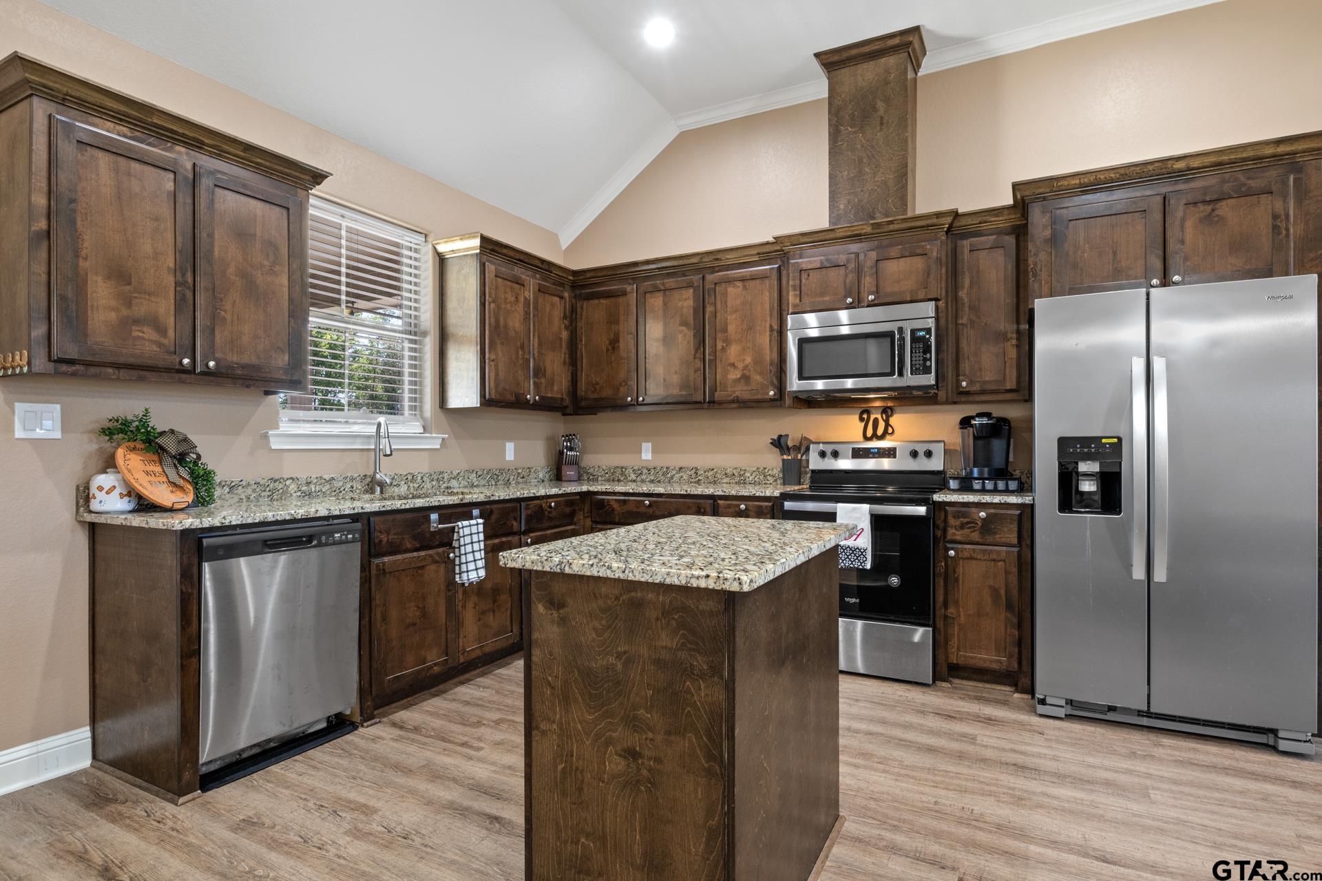 25 Private Road Pittsburg, TX 75686 - Photo 11 of 29 a kitchen with granite countertop stainless steel appliances and wooden cabinets