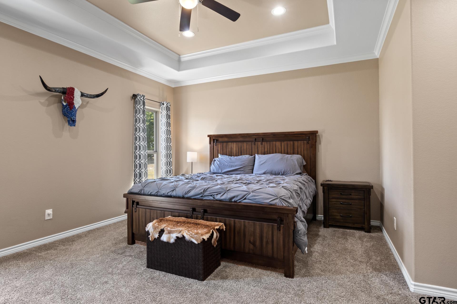 25 Private Road Pittsburg, TX 75686 - Photo 18 of 29 a bed sitting in a room next to a window