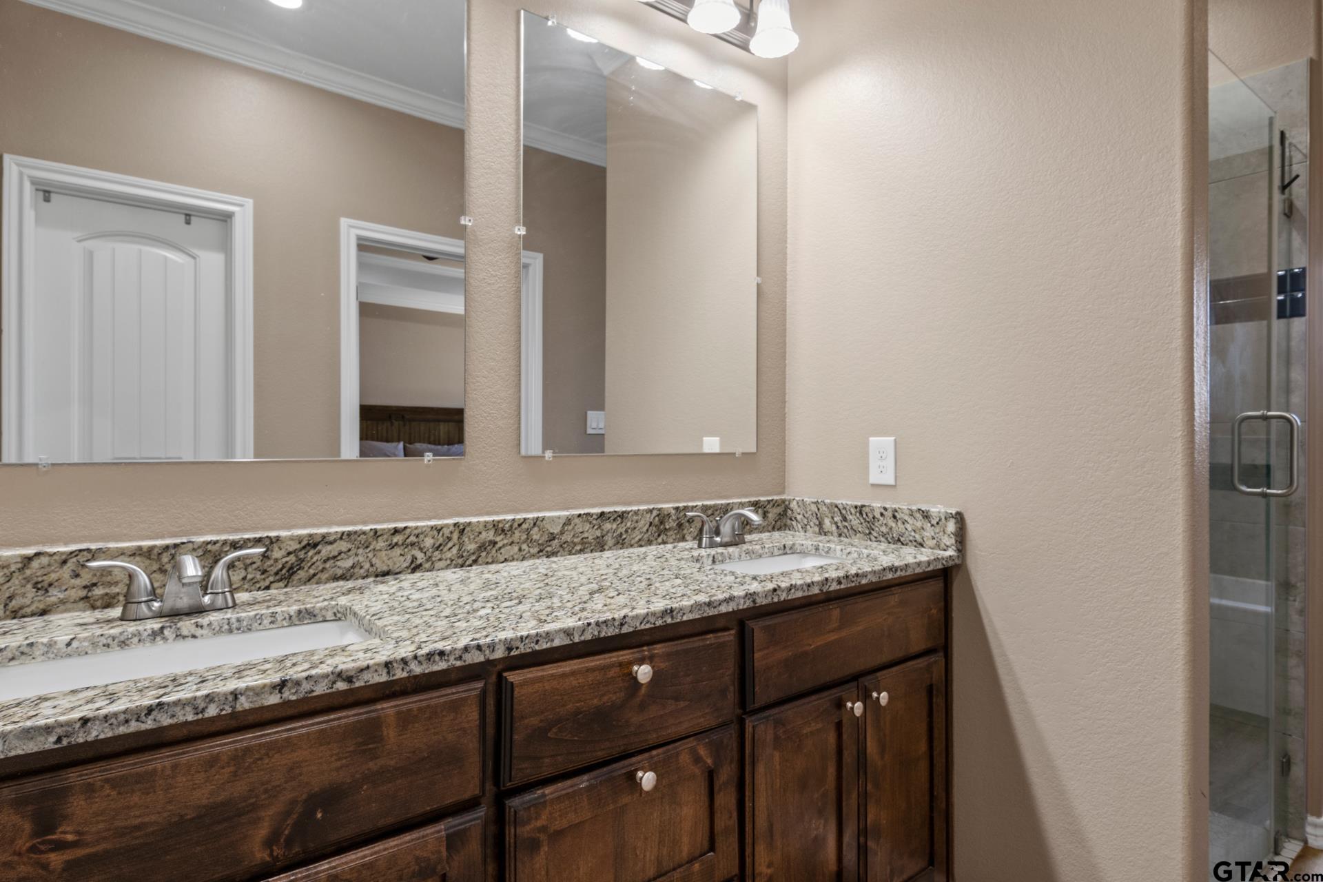 25 Private Road Pittsburg, TX 75686 - Photo 20 of 29 a bathroom with a granite countertop sink and a mirror