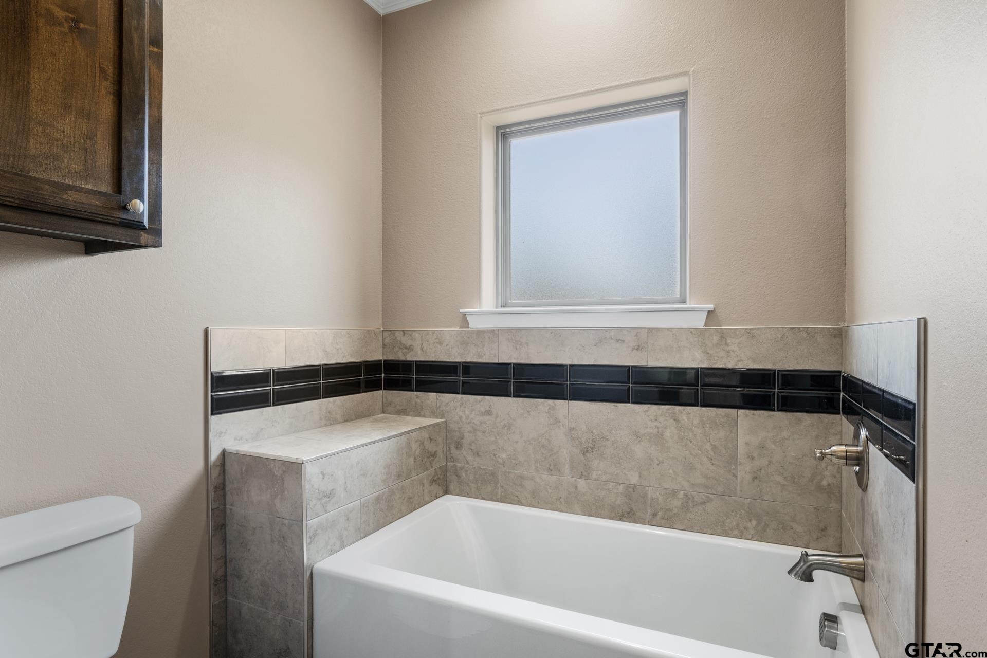 25 Private Road Pittsburg, TX 75686 - Photo 21 of 29 a bathroom with a bathtub and a window