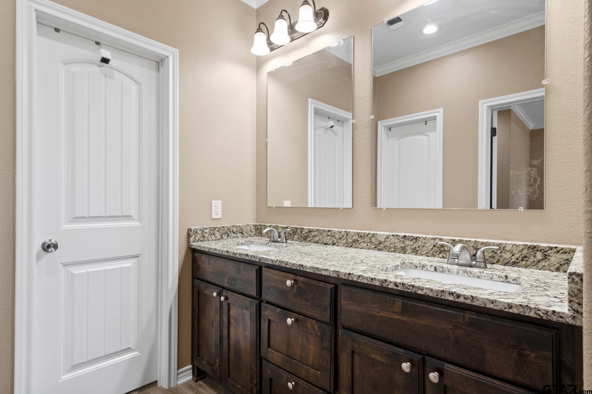 25 Private Road Pittsburg, TX 75686 - Photo 23 of 29 a bathroom with a granite countertop sink and a mirror