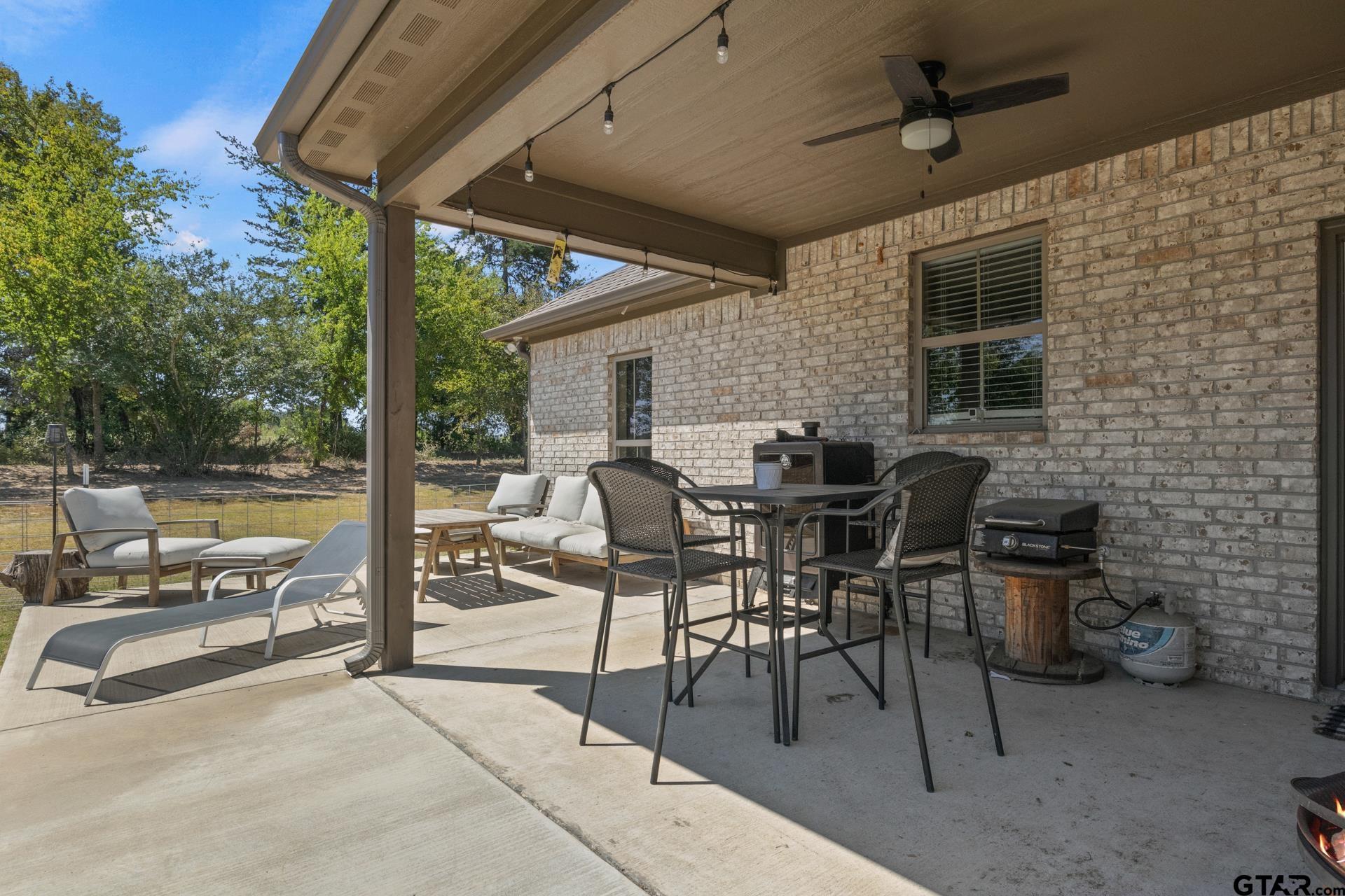 25 Private Road Pittsburg, TX 75686 - Photo 26 of 29 a view of a patio with a table and chairs