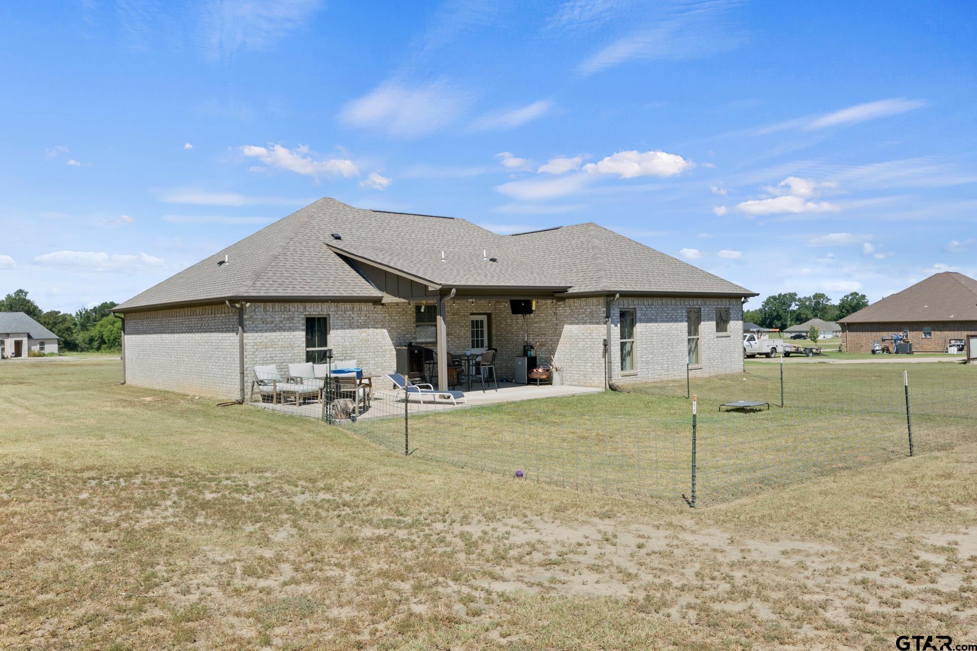 25 Private Road Pittsburg, TX 75686 - Photo 27 of 29 a view of a house with a backyard and porch