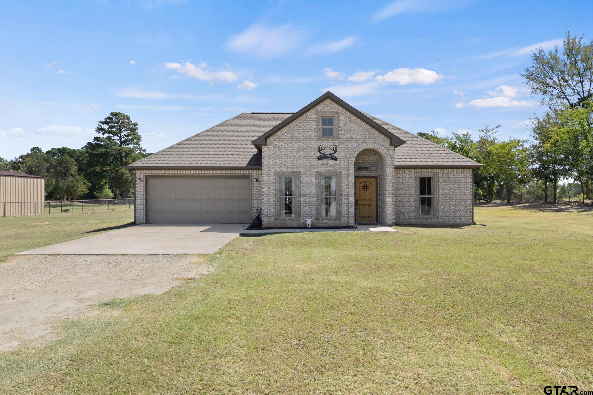 25 Private Road Pittsburg, TX 75686 - Photo 3 of 29 a view of a house with a yard and garage