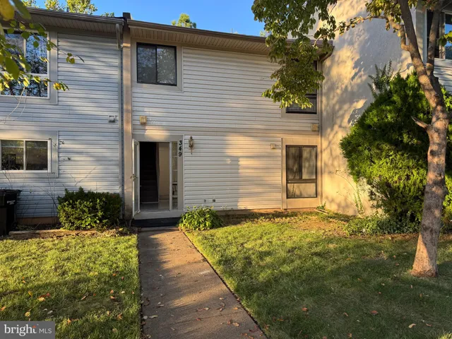a front view of house and yard with green space