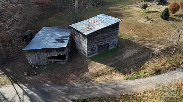 a wooden bench sitting in the middle of a yard