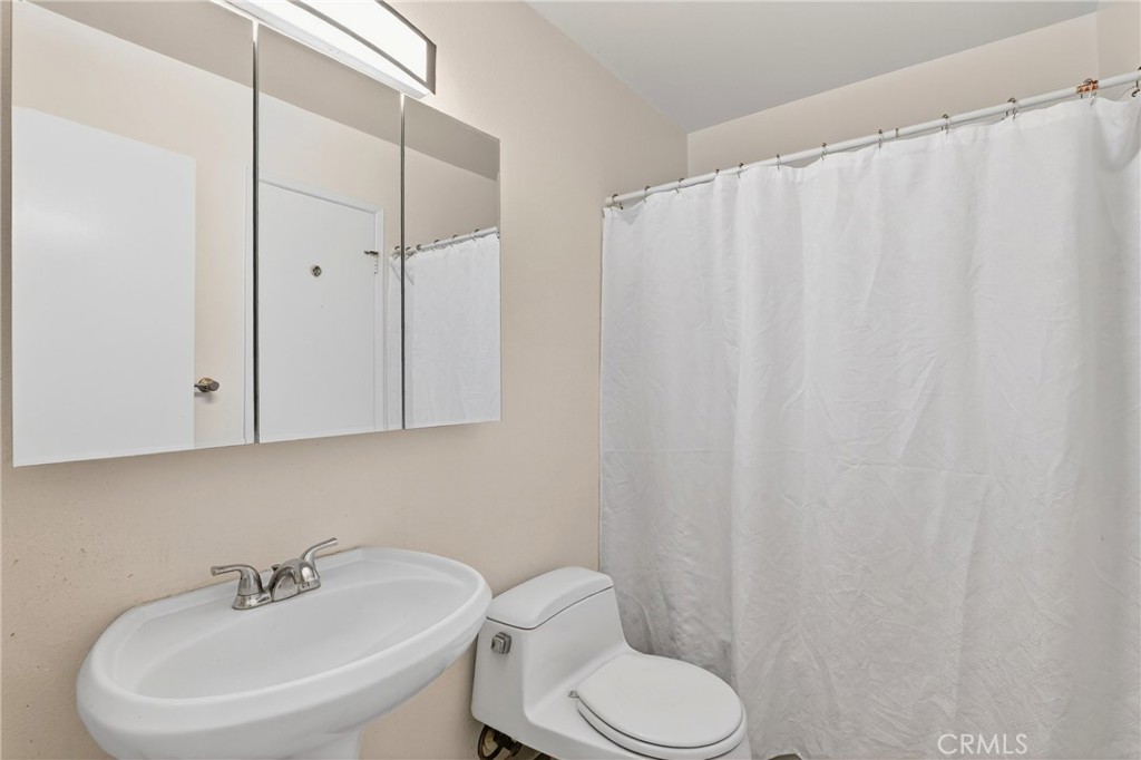 4140 Workman Mill Road, Unit 26 Whittier, CA 90601 - Photo 17 of 30 a bathroom with a sink a toilet and shower