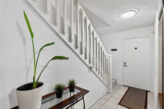 a kitchen with stainless steel appliances granite countertop a refrigerator a sink and wooden cabinets