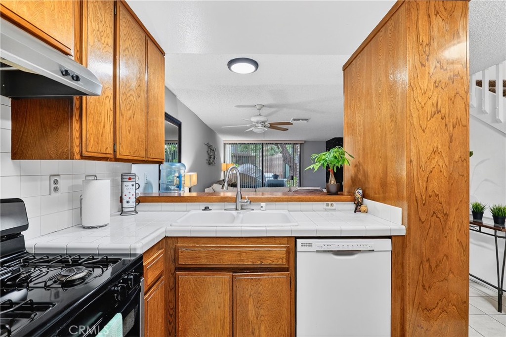 4140 Workman Mill Road, Unit 26 Whittier, CA 90601 - Photo 6 of 30 a kitchen with stainless steel appliances granite countertop a sink stove and cabinets