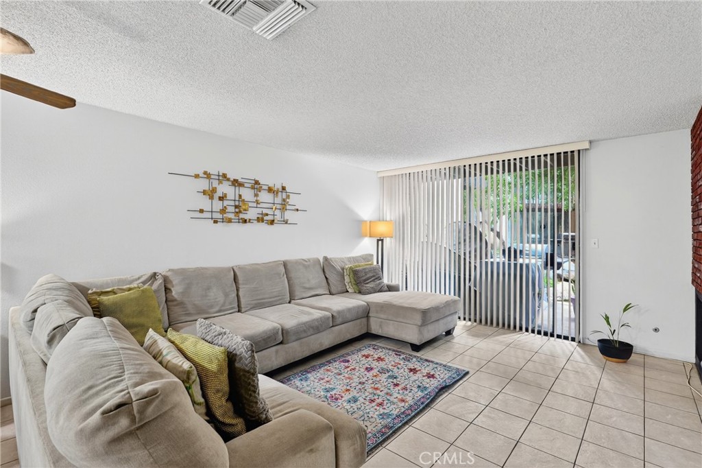 4140 Workman Mill Road, Unit 26 Whittier, CA 90601 - Photo 7 of 30 a living room with furniture and a floor to ceiling window