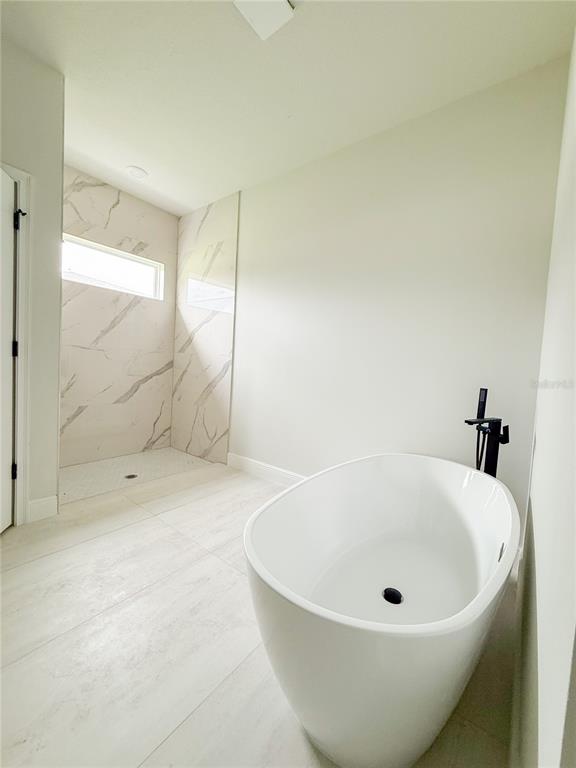 15716 Southwest 46th Ave Road Ocala, FL 34473 - Photo 25 of 31 a bathroom with a tub and shower