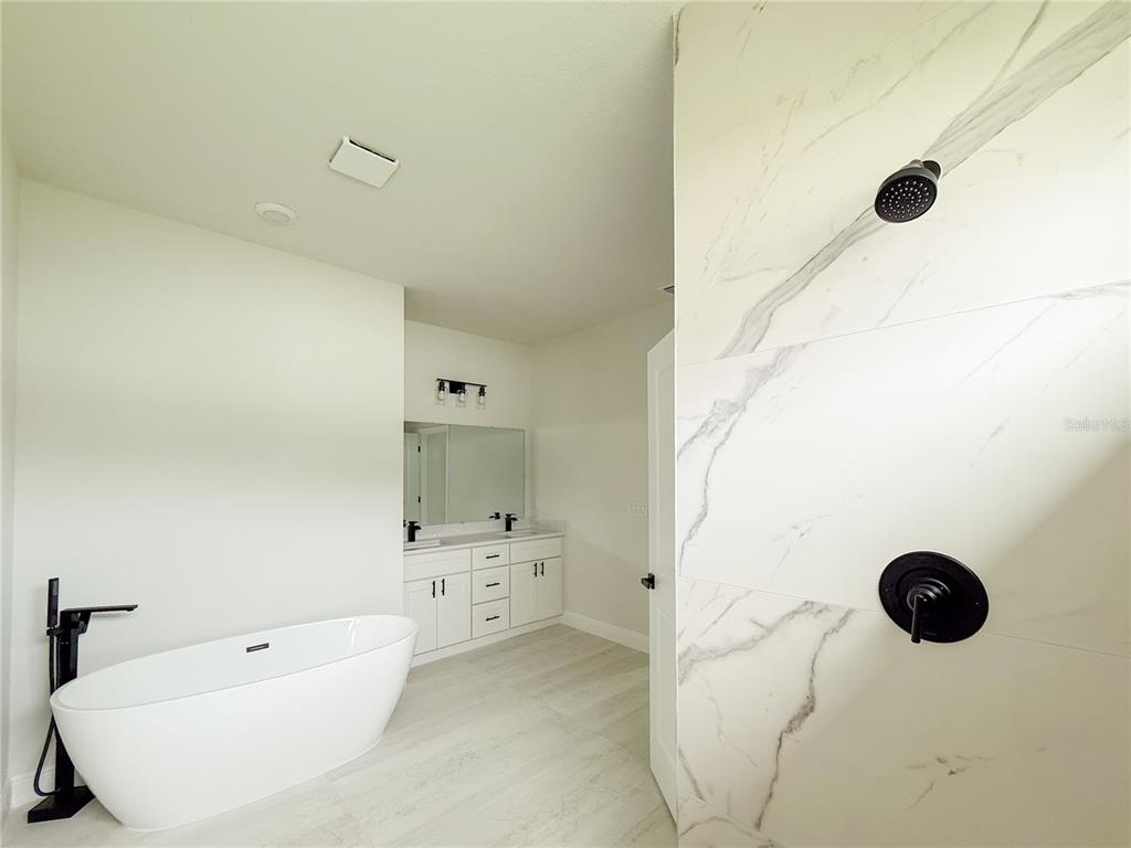 15716 Southwest 46th Ave Road Ocala, FL 34473 - Photo 26 of 31 a bathroom with a tub sink and shower