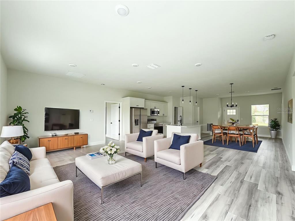 15716 Southwest 46th Ave Road Ocala, FL 34473 - Photo 28 of 31 a living room with furniture and a flat screen tv