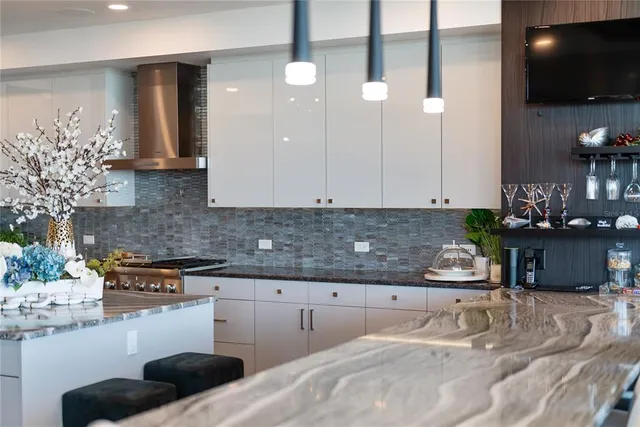 a kitchen with granite countertop white cabinets and white appliances