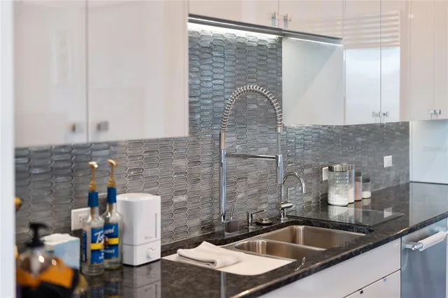 a living room with furniture and floor to ceiling windows