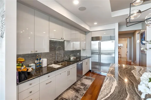 a dining room with furniture a chandelier and wooden floor