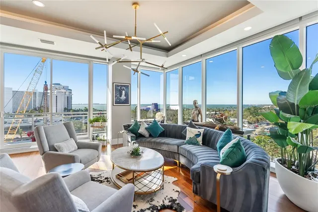 a view of a dining room with furniture wooden floor and chandelier