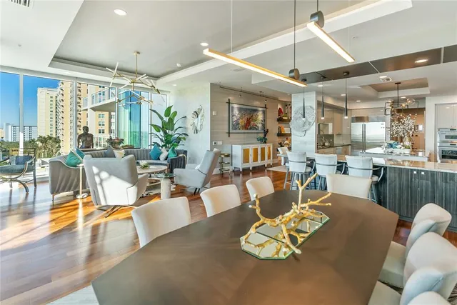 a kitchen with stainless steel appliances kitchen island granite countertop a refrigerator and a stove top oven