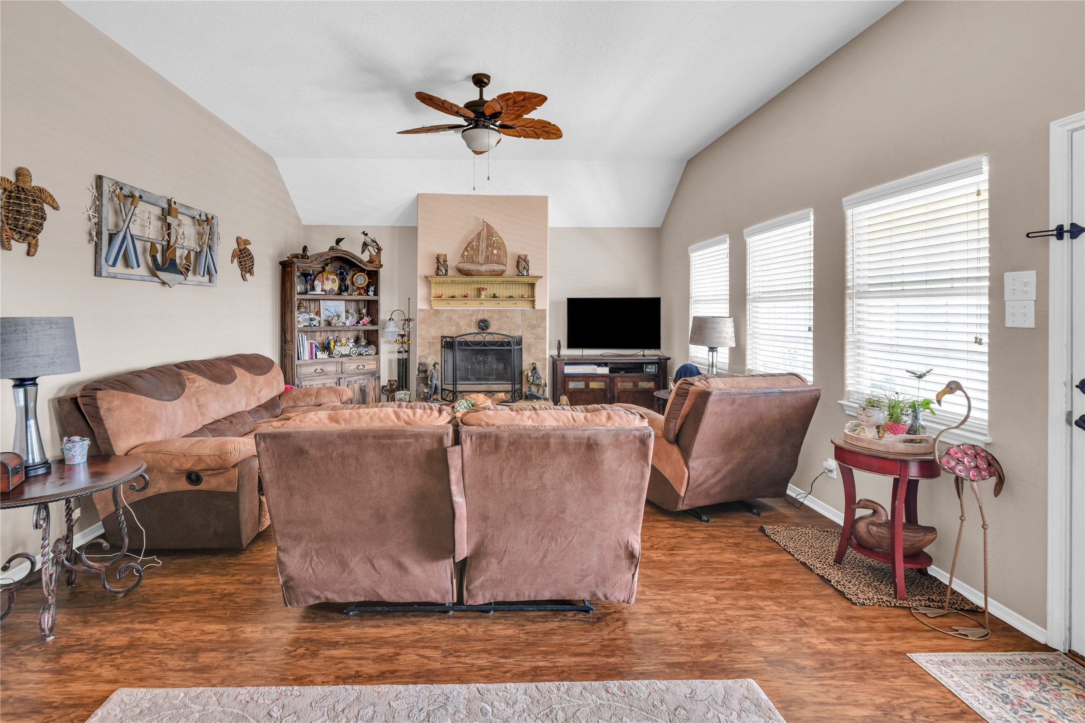 115 Driftwood Road Freeport, TX 77541 - Photo 7 of 21 a living room with furniture a fireplace and a flat screen tv