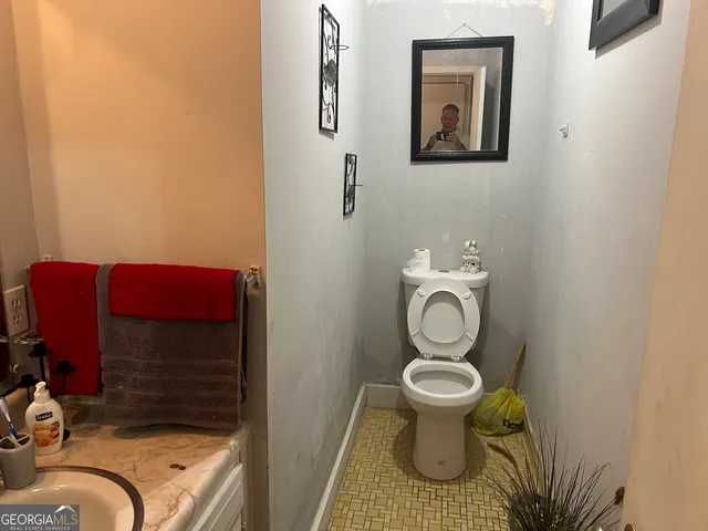 a bathroom with a toilet and a sink