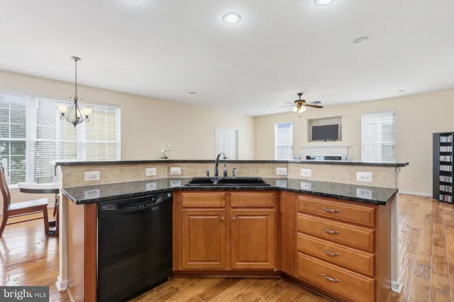 a kitchen with granite countertop a sink and cabinets