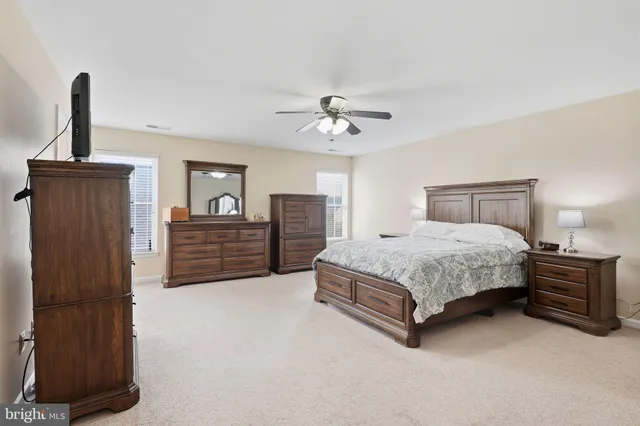 a spacious bedroom with a bed and a table