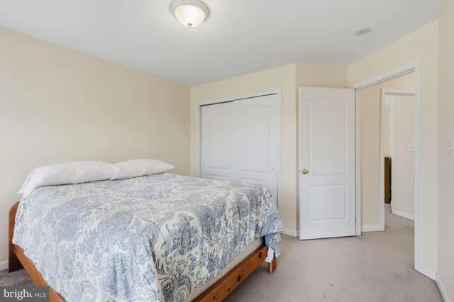 a bedroom with a bed and a closet