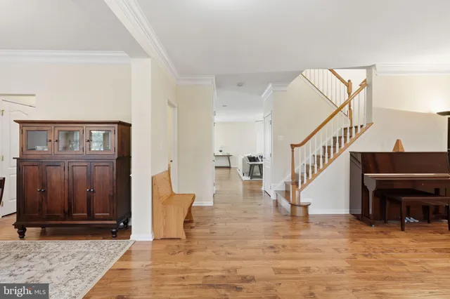 a view of entryway and hall with wooden floor