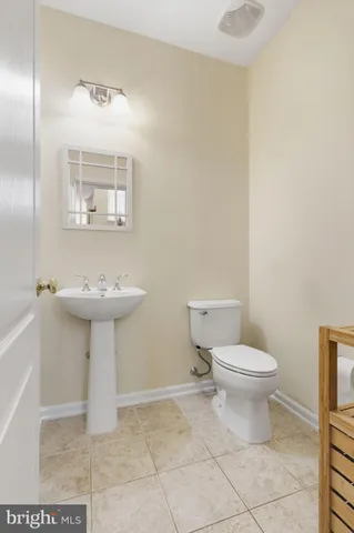 a bathroom with a sink toilet and a mirror
