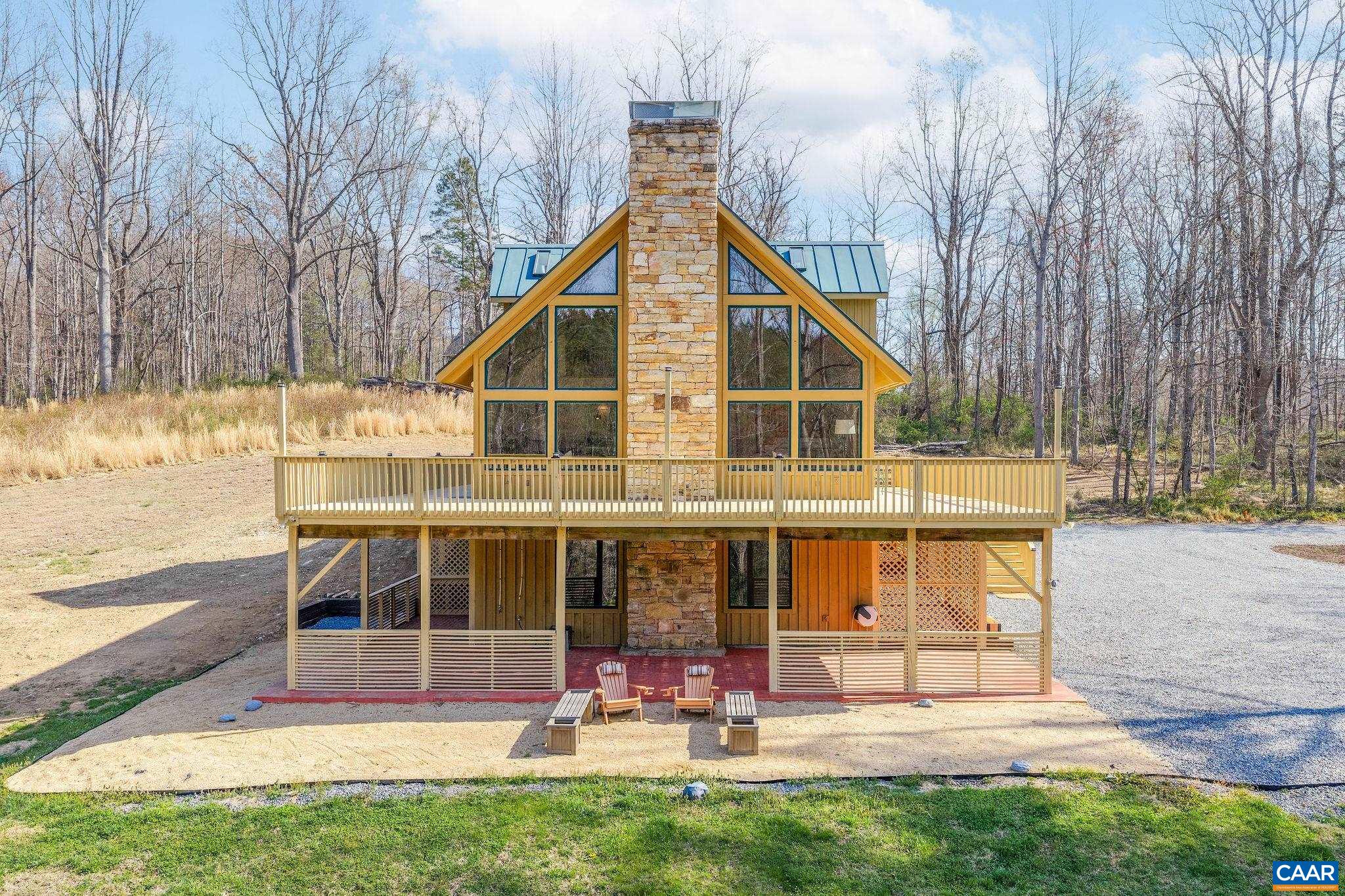 7102 Blackwells Hollow Road Crozet, VA 22932 - Photo 1 of 57 a view of a house with large windows and a small yard