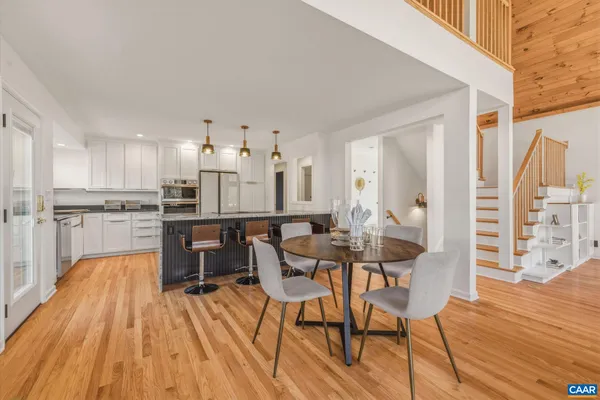 a view of a dining room with furniture and wooden floor
