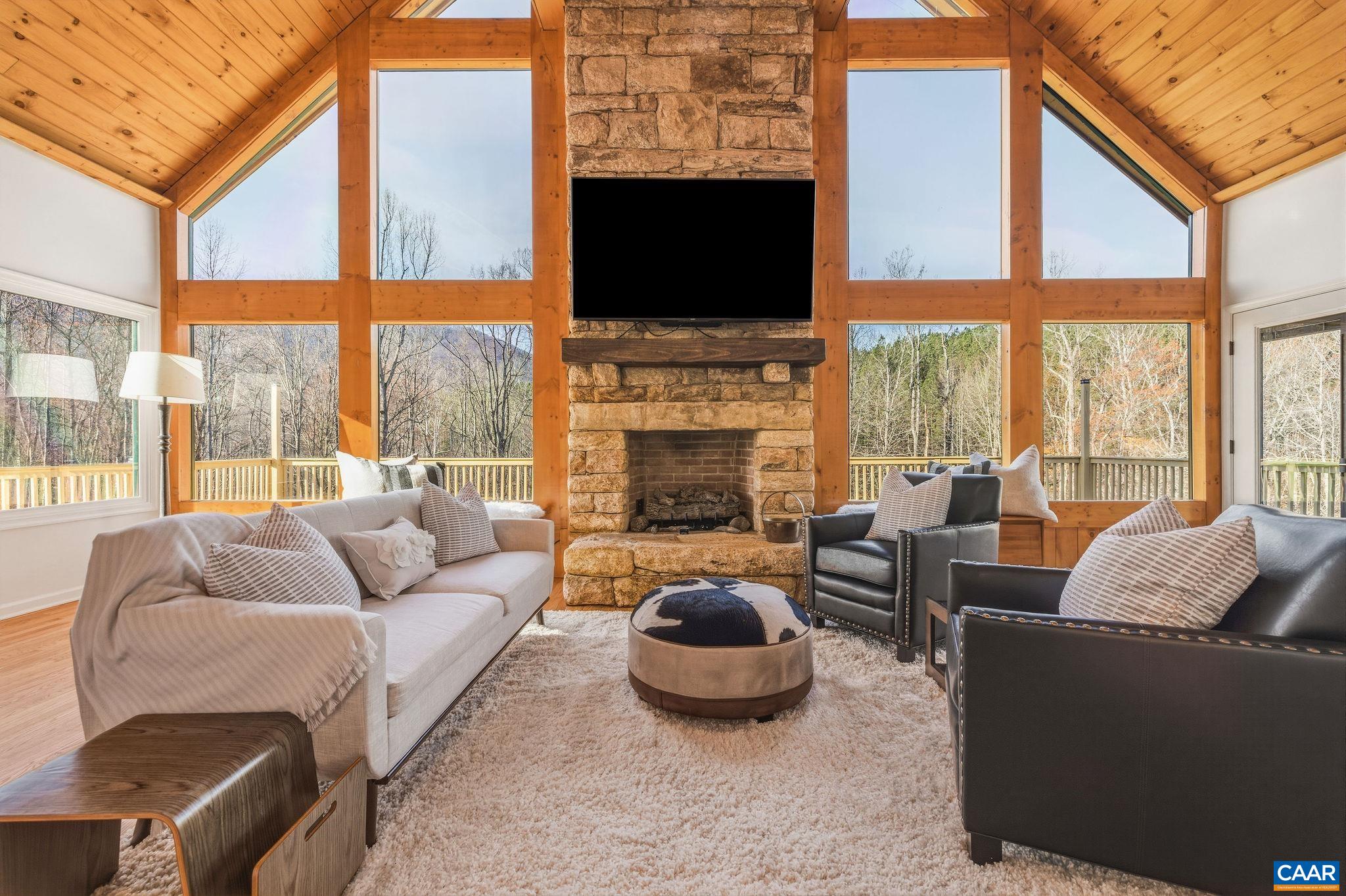7102 Blackwells Hollow Road Crozet, VA 22932 - Photo 13 of 57 a living room with furniture a fireplace and a flat screen tv