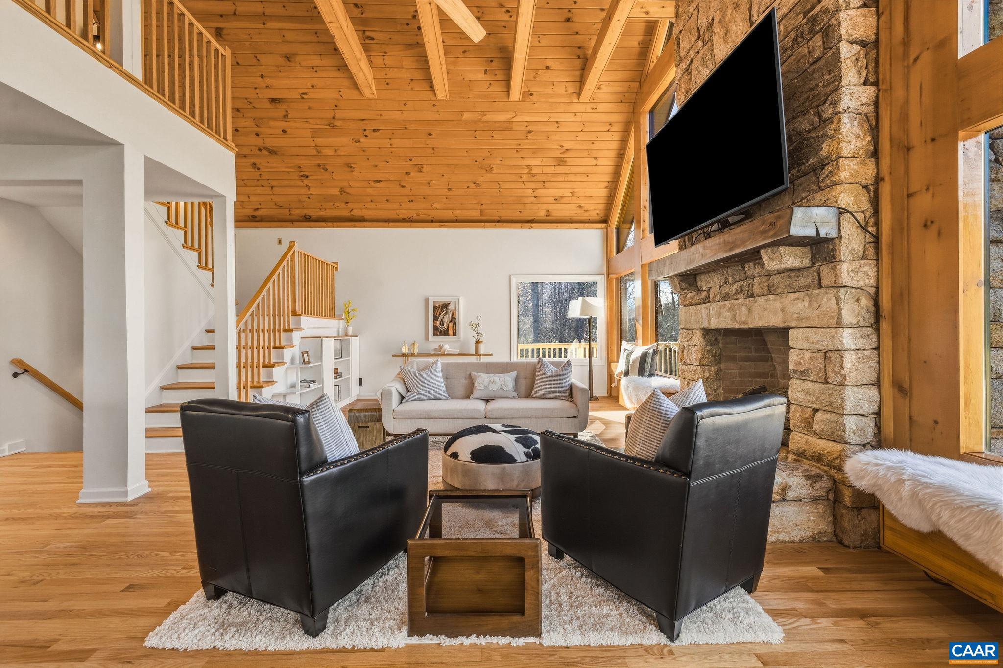 7102 Blackwells Hollow Road Crozet, VA 22932 - Photo 14 of 57 a living room with fireplace furniture and a flat screen tv