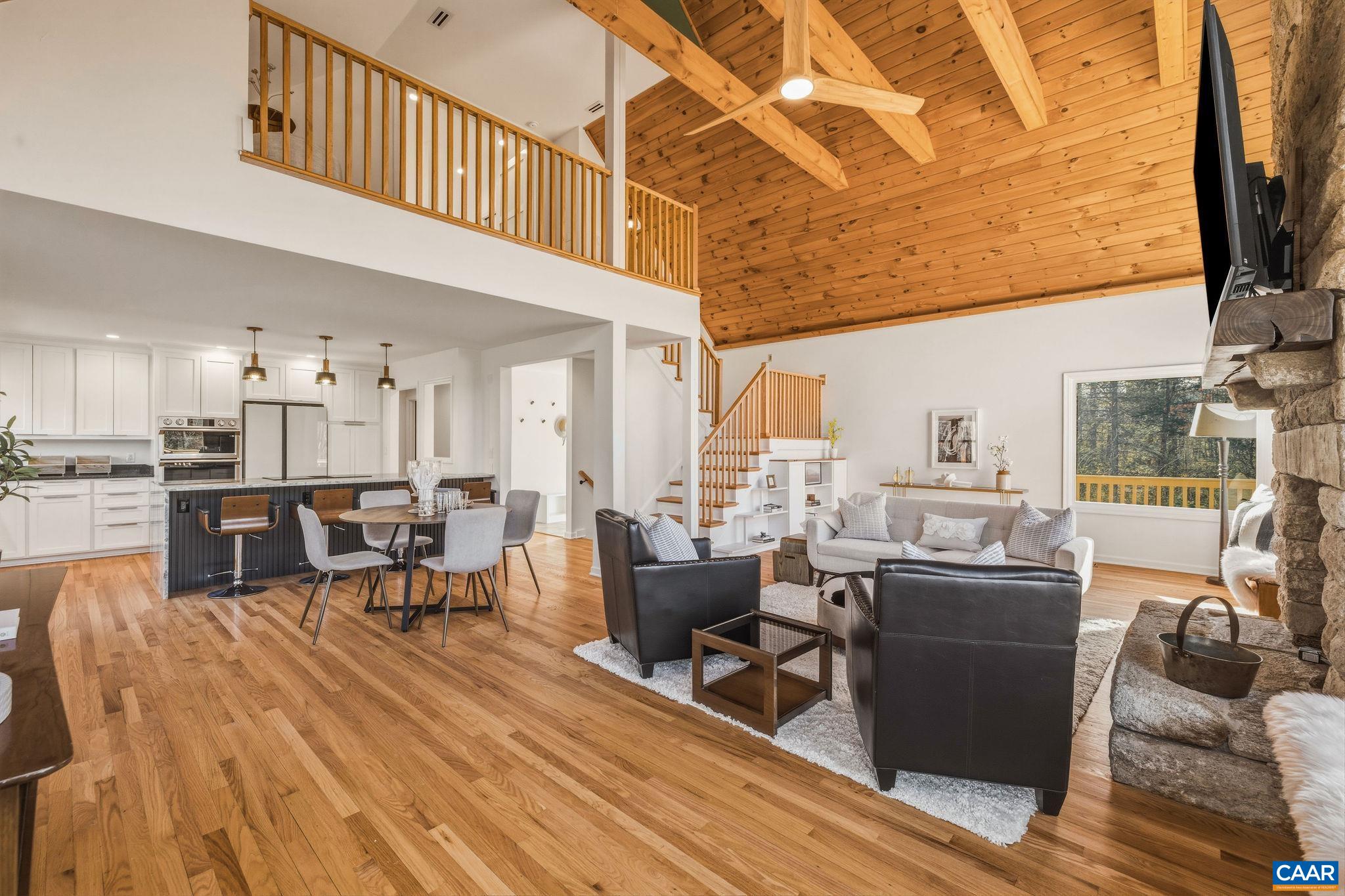7102 Blackwells Hollow Road Crozet, VA 22932 - Photo 15 of 57 a living room with lots of furniture and a kitchen view