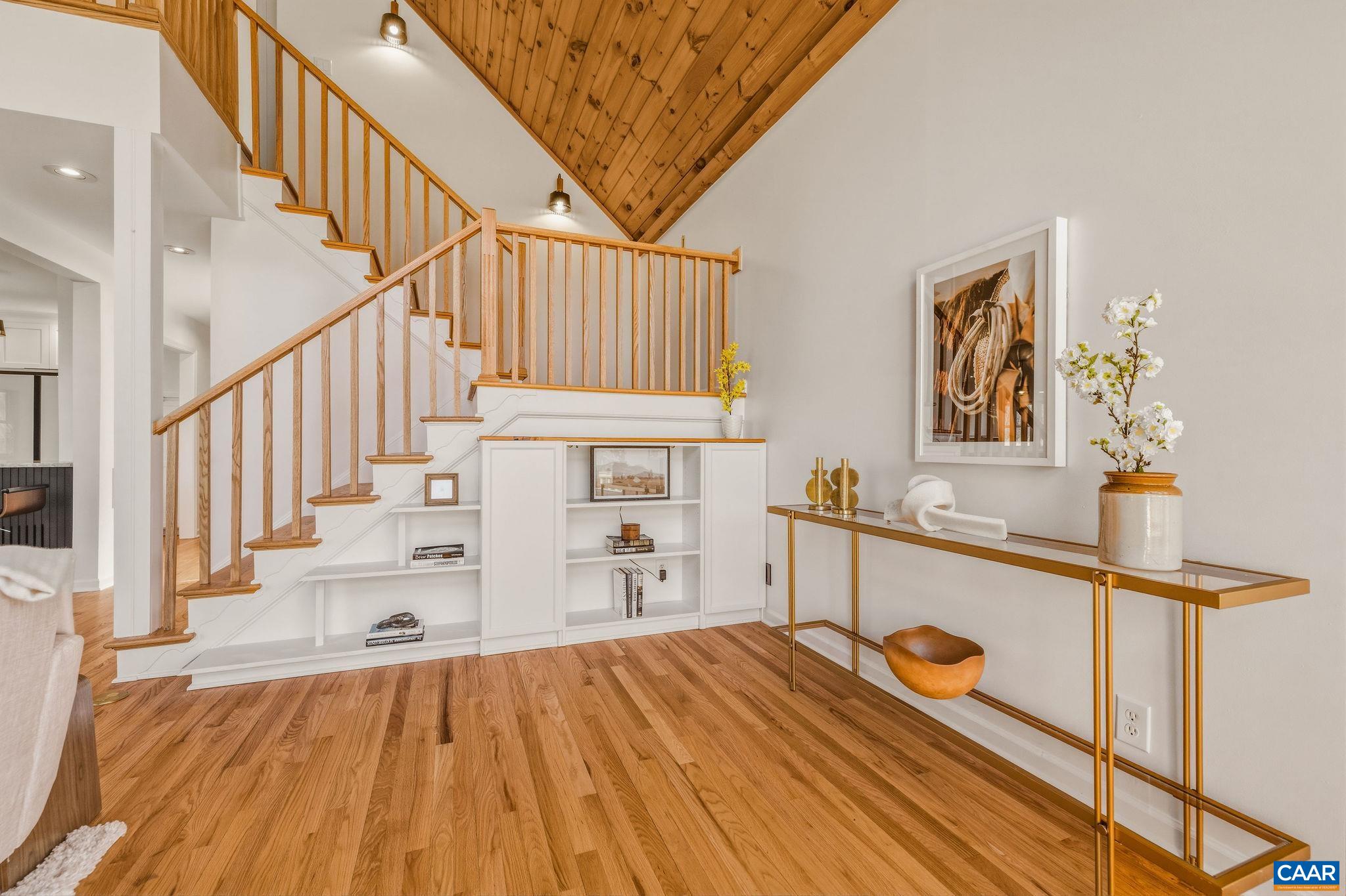 7102 Blackwells Hollow Road Crozet, VA 22932 - Photo 16 of 57 a view of a hallway with wooden floor and staircase