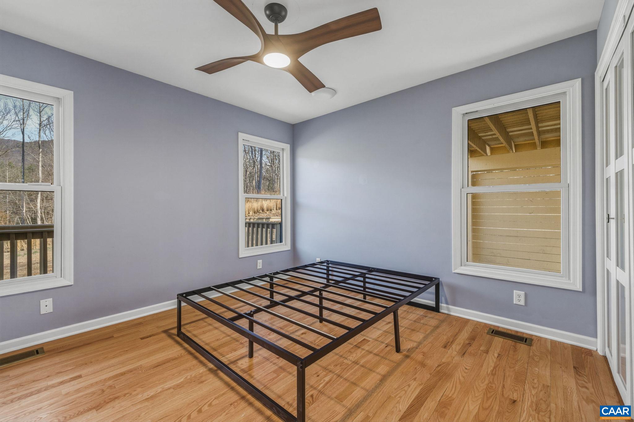 7102 Blackwells Hollow Road Crozet, VA 22932 - Photo 19 of 57 an empty room with windows and ceiling fan