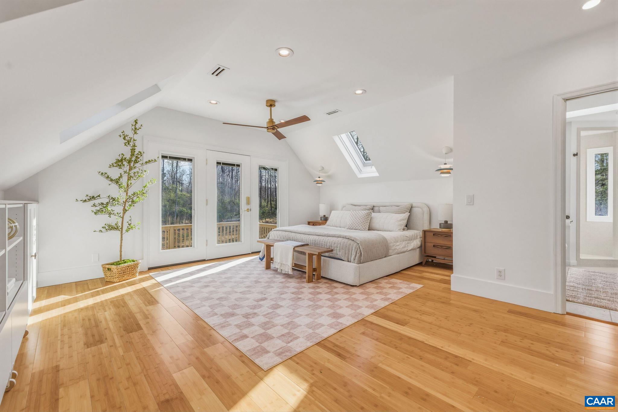 7102 Blackwells Hollow Road Crozet, VA 22932 - Photo 22 of 57 a spacious bedroom with a bed and a large window