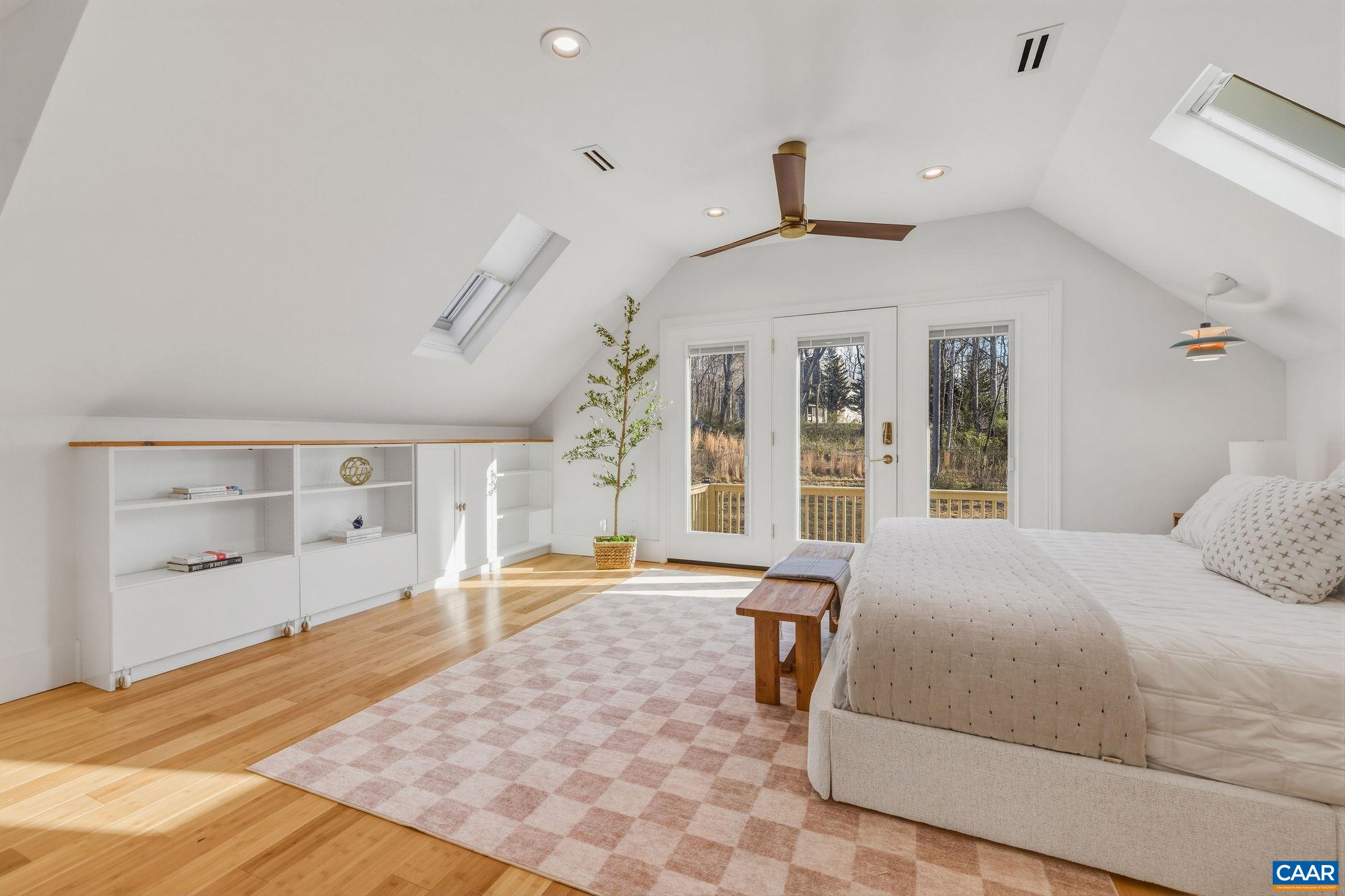 7102 Blackwells Hollow Road Crozet, VA 22932 - Photo 23 of 57 a bedroom with a large bed and wooden floor