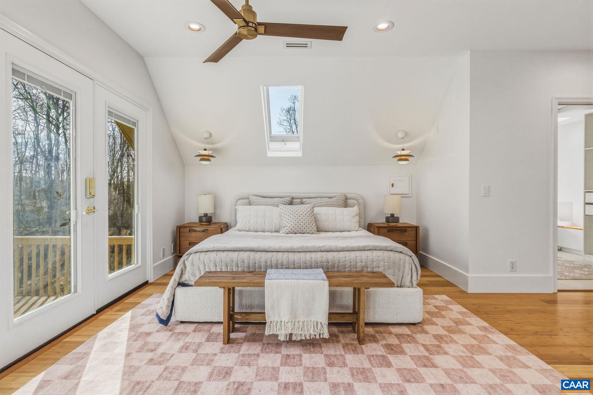 7102 Blackwells Hollow Road Crozet, VA 22932 - Photo 24 of 57 a spacious bedroom with a bed and wooden floor