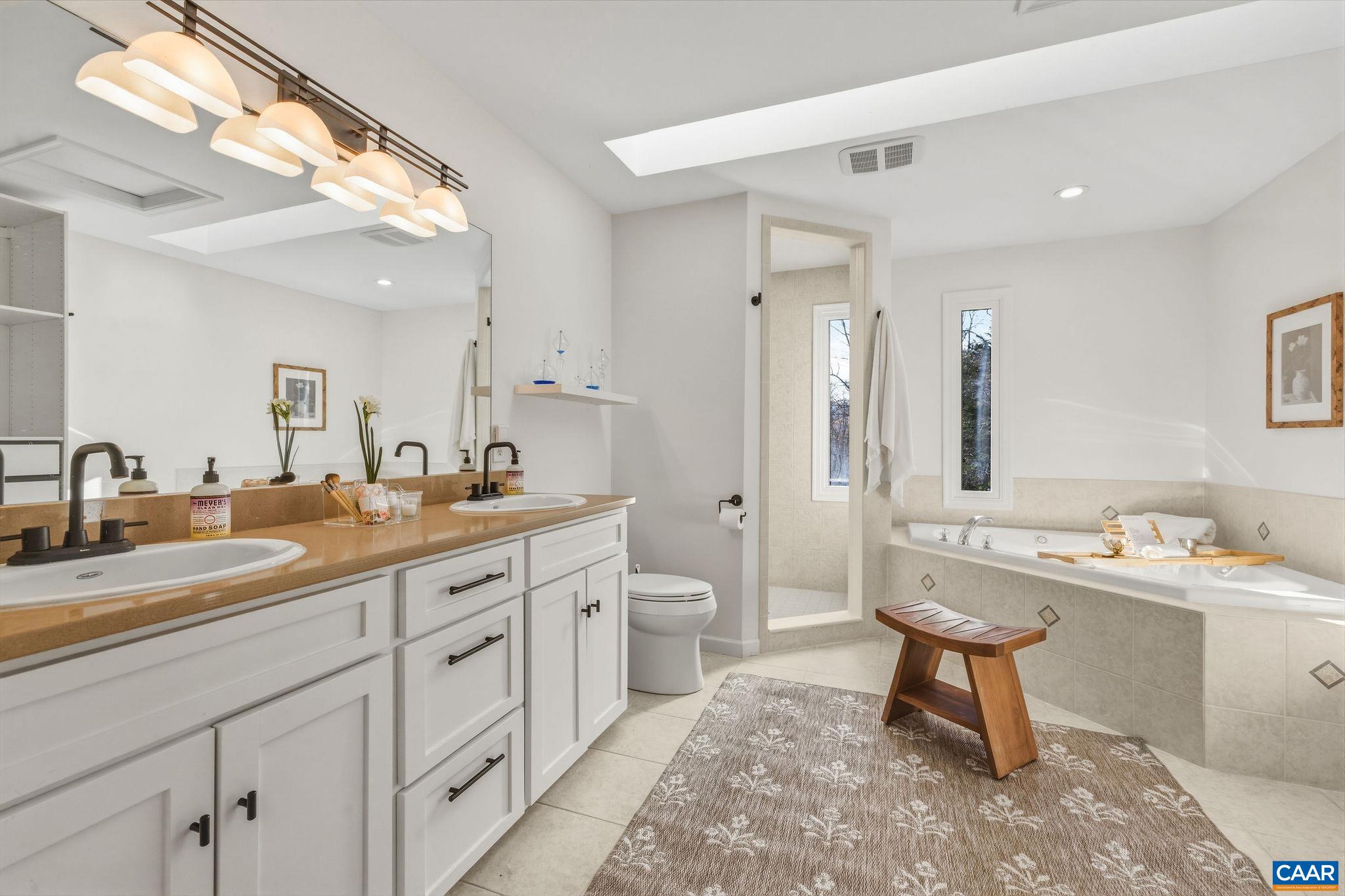 7102 Blackwells Hollow Road Crozet, VA 22932 - Photo 27 of 57 a spacious bathroom with a double vanity sink mirror and a