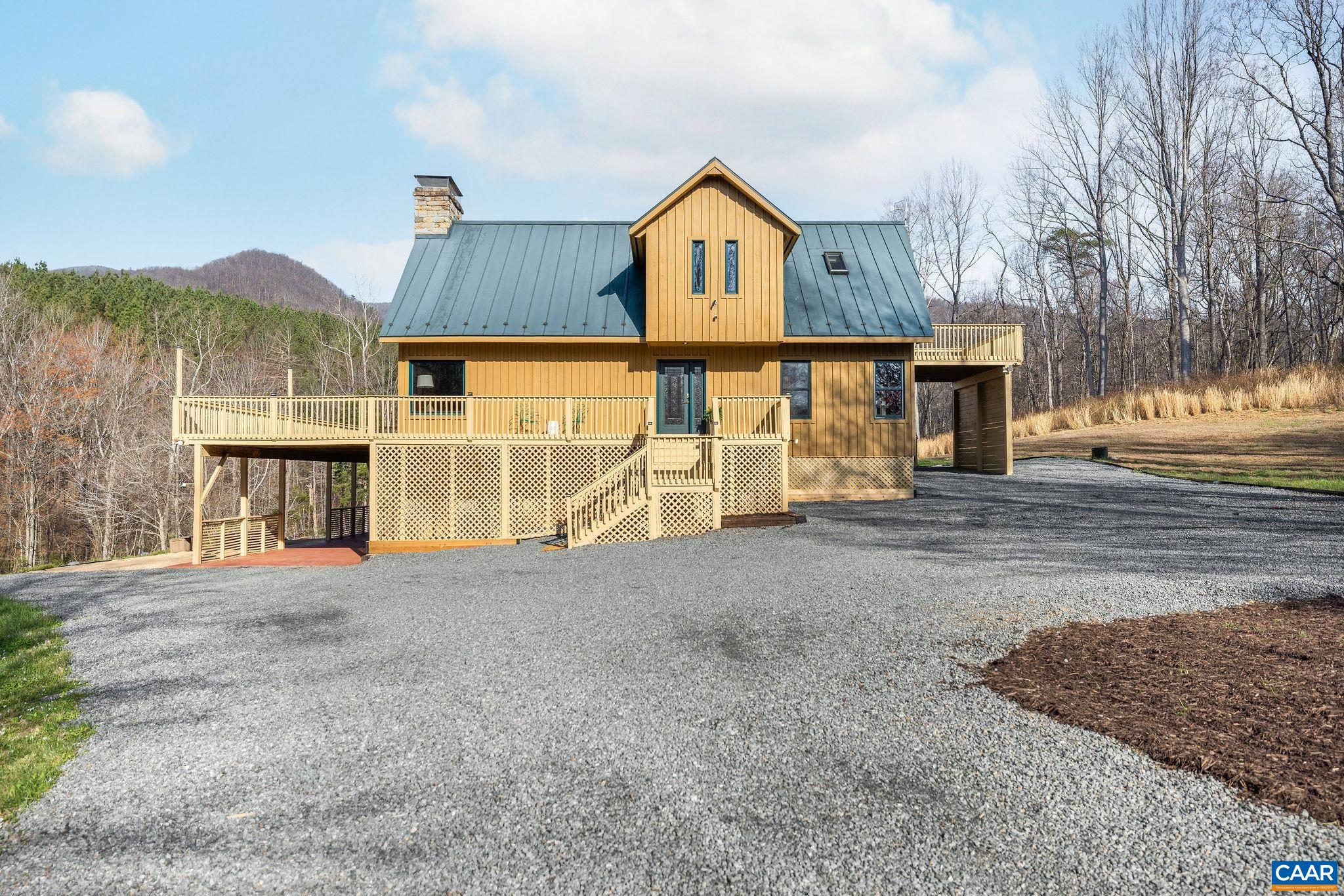 7102 Blackwells Hollow Road Crozet, VA 22932 - Photo 42 of 57 a view of a house with a yard