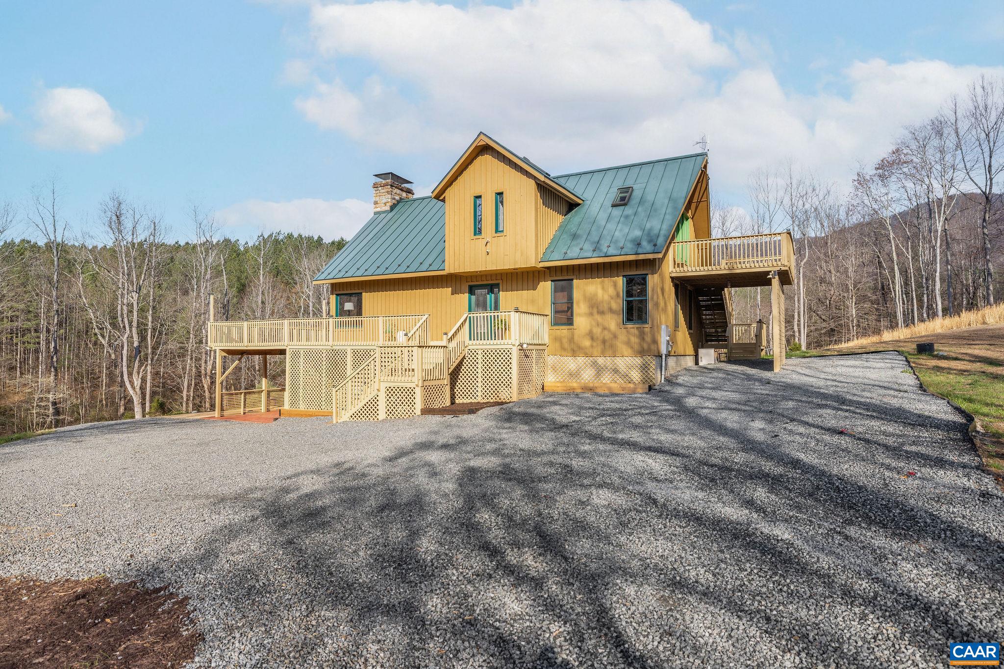 7102 Blackwells Hollow Road Crozet, VA 22932 - Photo 43 of 57 a front view of a house with a yard and garage