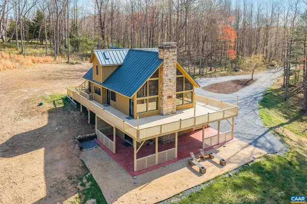 a view of a house with backyard and a wooden fence