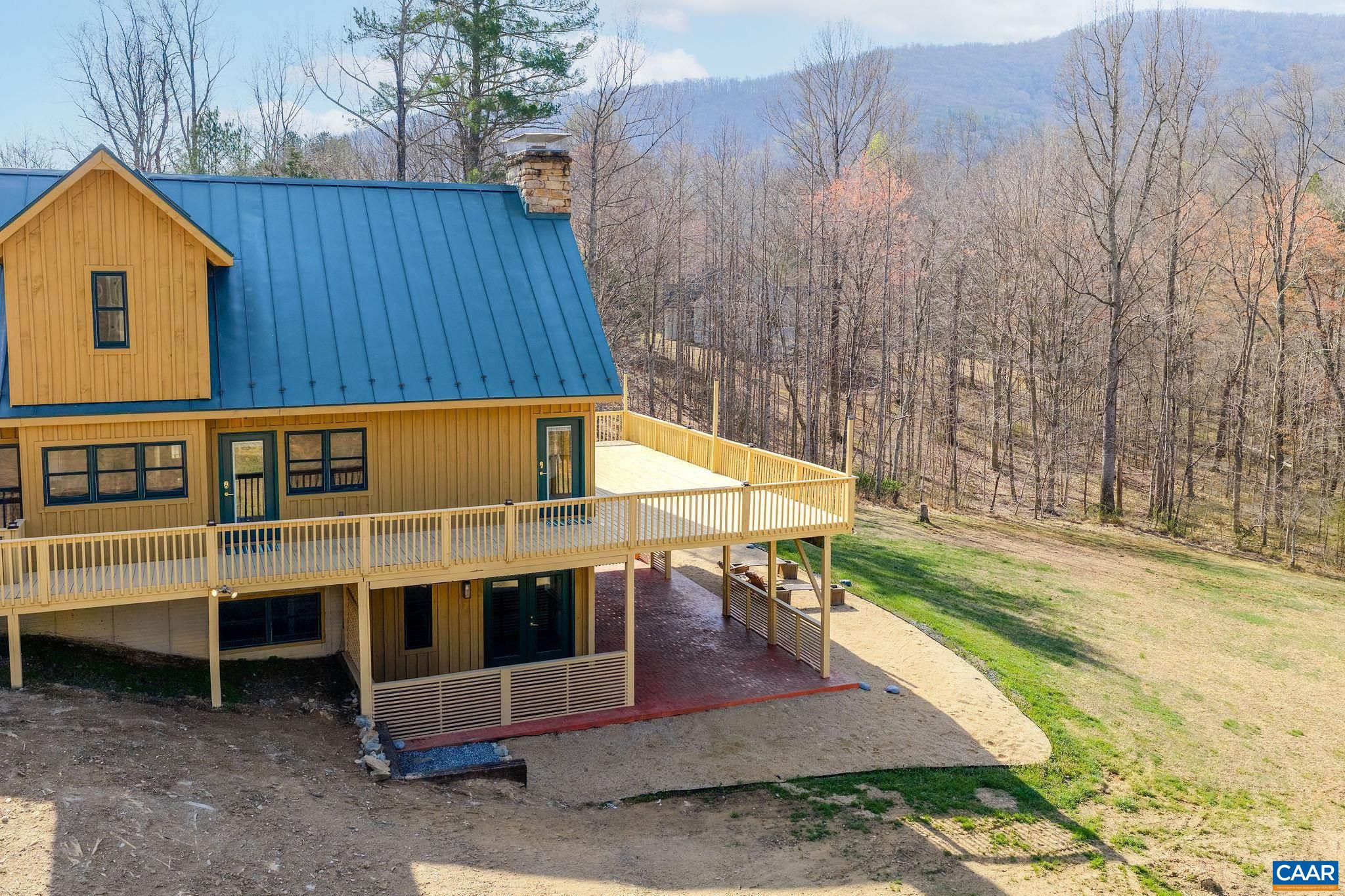 7102 Blackwells Hollow Road Crozet, VA 22932 - Photo 52 of 57 a view of a house with backyard and a wooden fence