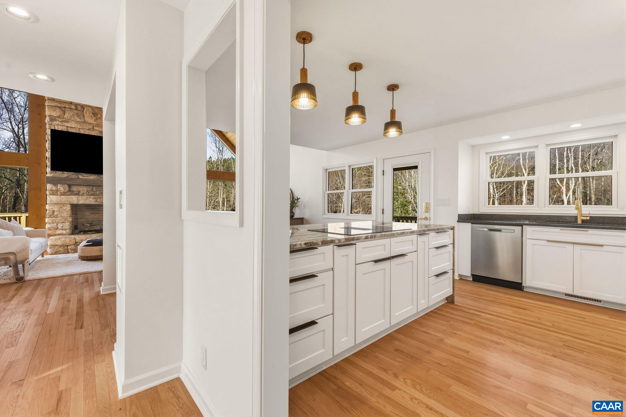 7102 Blackwells Hollow Road Crozet, VA 22932 - Photo 6 of 57 a large white kitchen with cabinets a sink and appliances